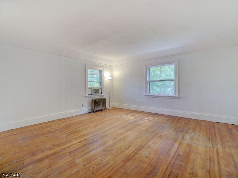 449 Grove Street Montclair, NJ 07043 - Photo 13 of 23 an empty room with wooden floor and windows