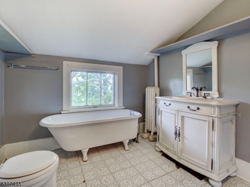 449 Grove Street Montclair, NJ 07043 - Photo 21 of 23 a spacious bathroom with a bathtub sink mirror and toilet