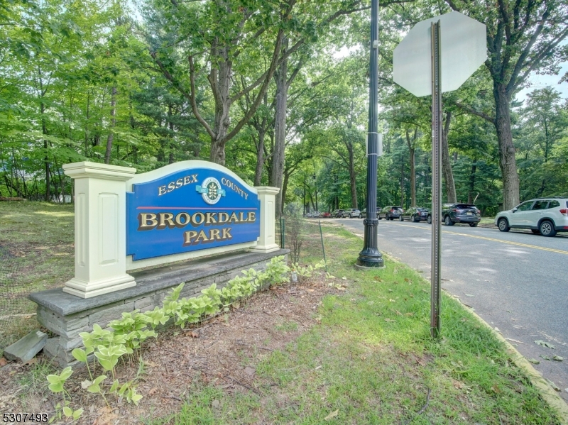 449 Grove Street Montclair, NJ 07043 - Photo 22 of 23 a sign board with a bench and trees