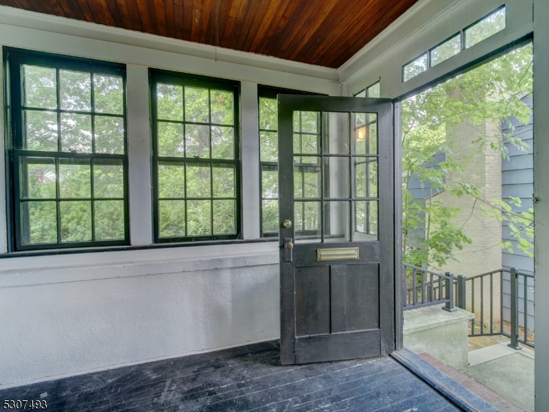 449 Grove Street Montclair, NJ 07043 - Photo 3 of 23 a view of an empty room with wooden floor and a window