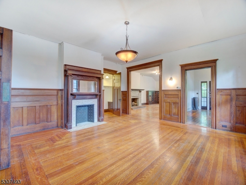 449 Grove Street Montclair, NJ 07043 - Photo 7 of 23 a view of a livingroom with wooden floor and a kitchen space
