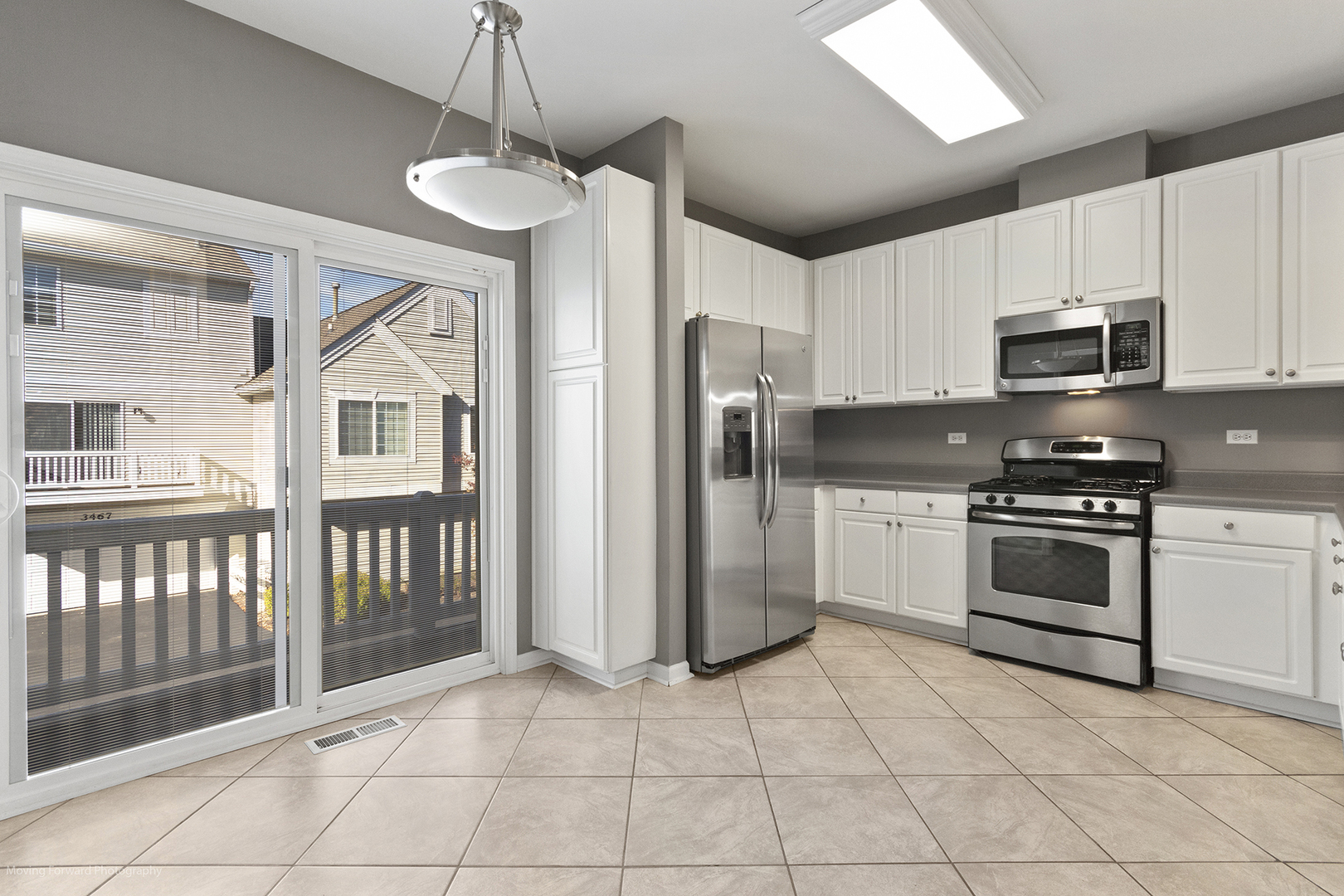 3473 Ravinia Circle Aurora, IL 60504 - Photo 3 of 17 a kitchen with stainless steel appliances granite countertop a stove a sink and a refrigerator
