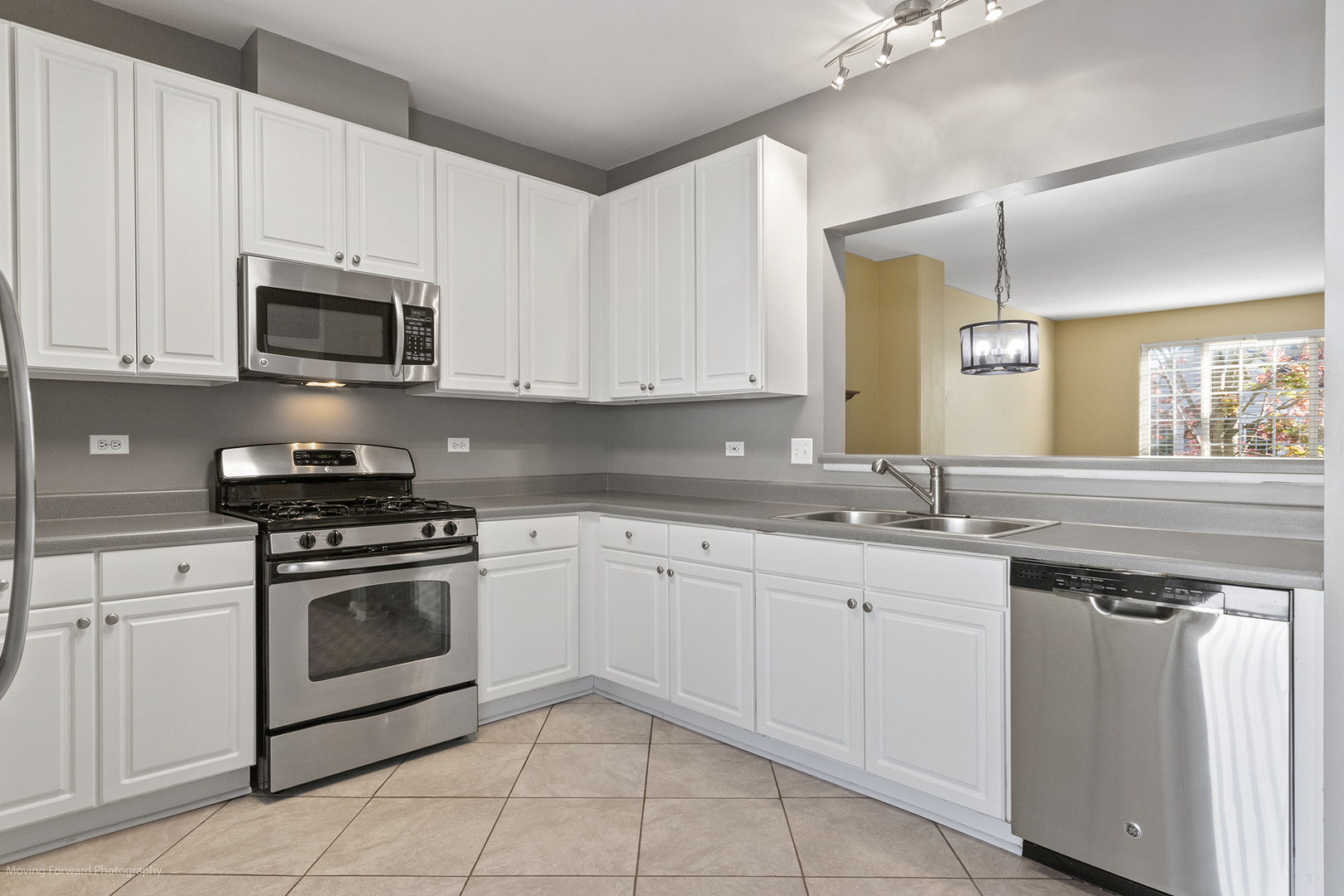 3473 Ravinia Circle Aurora, IL 60504 - Photo 4 of 17 a kitchen with white cabinets stainless steel appliances and sink