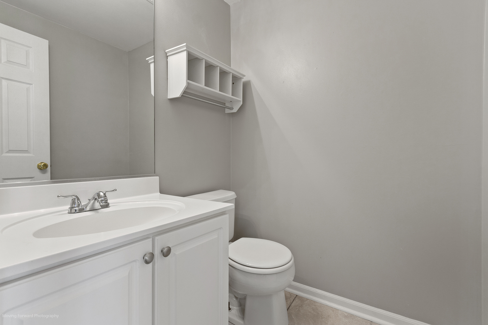 3473 Ravinia Circle Aurora, IL 60504 - Photo 5 of 17 a bathroom with a sink a toilet and mirror