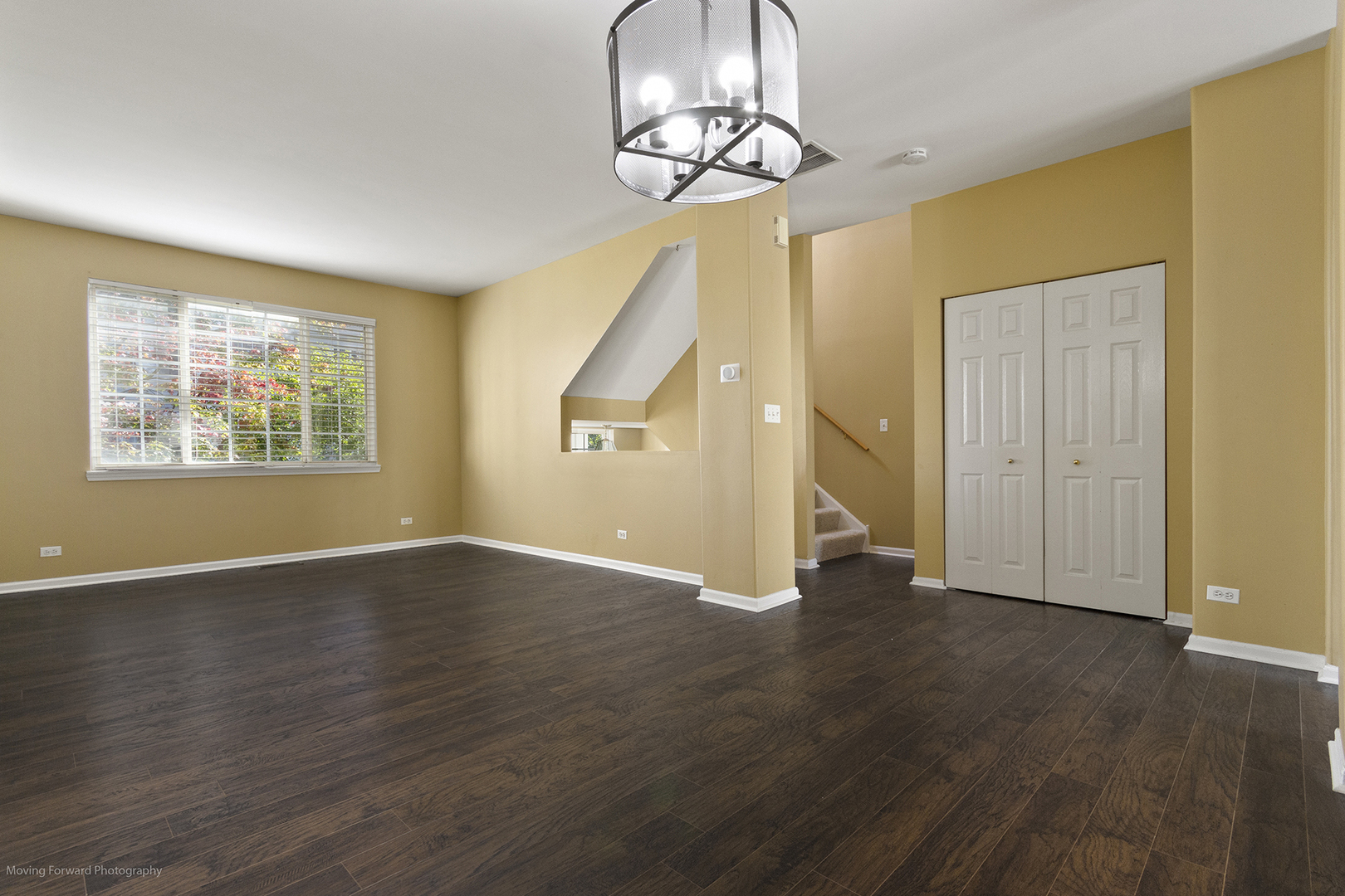 3473 Ravinia Circle Aurora, IL 60504 - Photo 6 of 17 a view of an empty room with wooden floor and a window