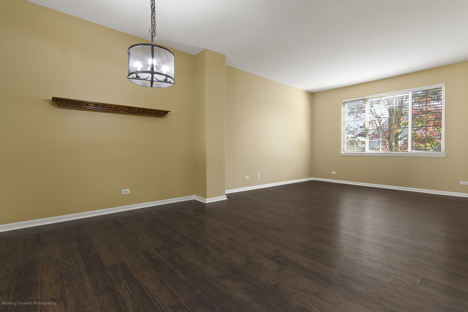 3473 Ravinia Circle Aurora, IL 60504 - Photo 7 of 17 an empty room with wooden floor chandelier and windows