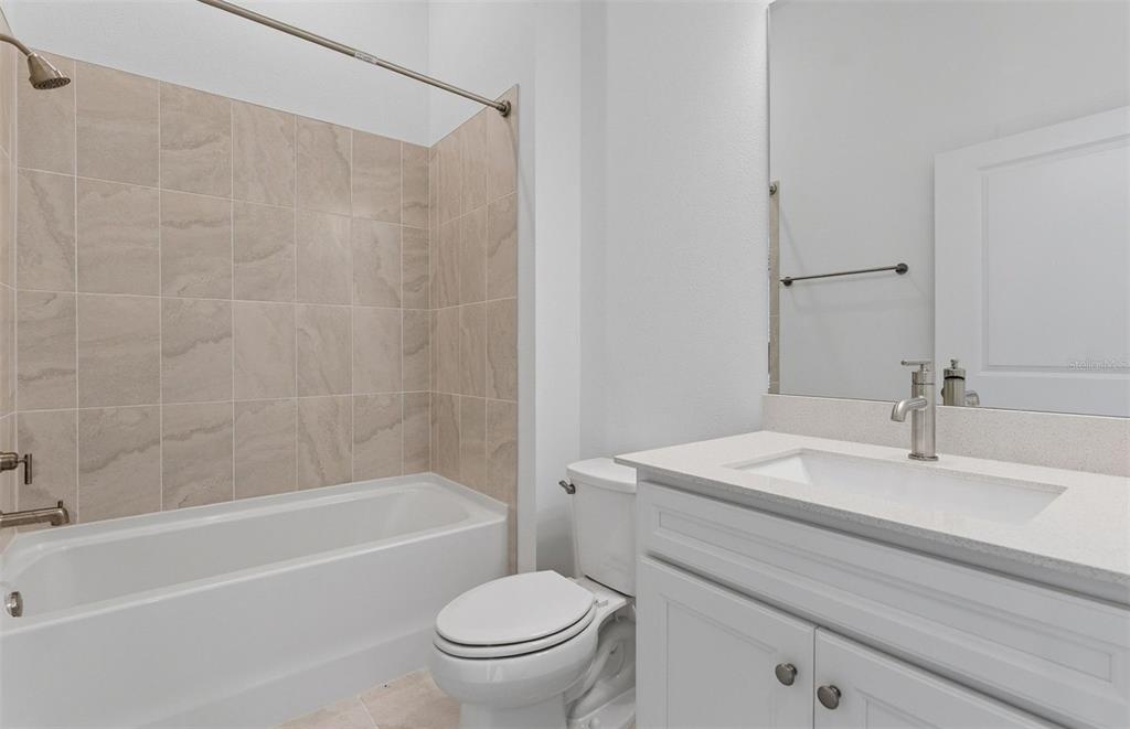 1683 Valier Point Zephyrhills, FL 33541 - Photo 12 of 20 a bathroom with a sink a toilet and a bathtub