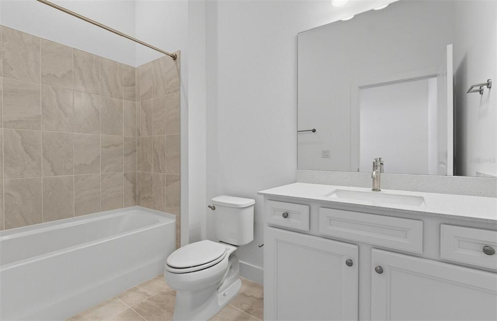 1683 Valier Point Zephyrhills, FL 33541 - Photo 14 of 20 a bathroom with a sink toilet and shower