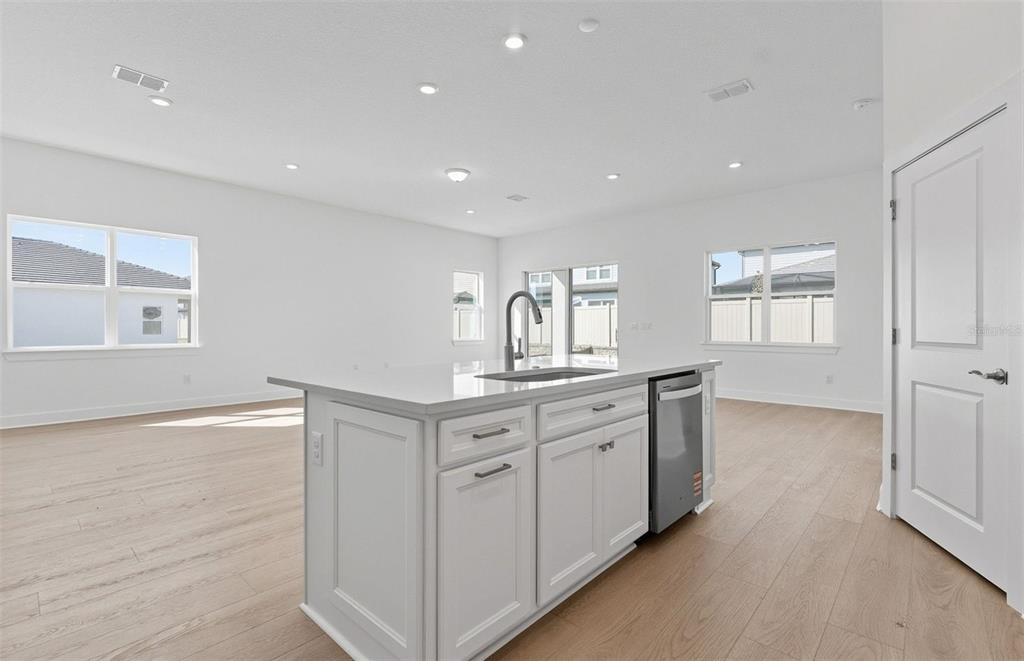 1683 Valier Point Zephyrhills, FL 33541 - Photo 3 of 20 a kitchen with white cabinets