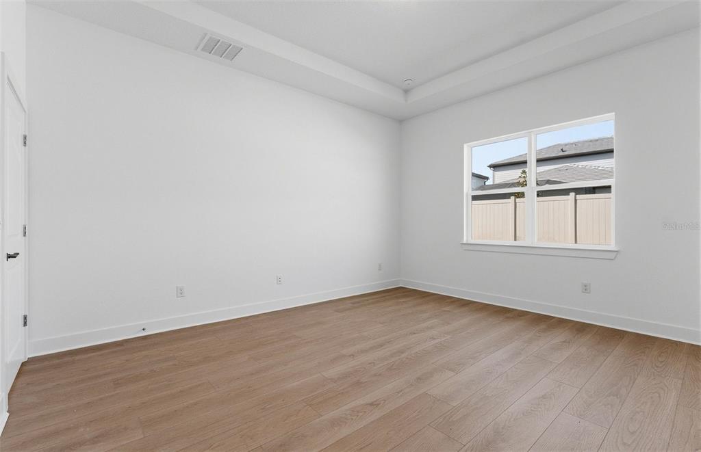 1683 Valier Point Zephyrhills, FL 33541 - Photo 7 of 20 wooden floor in an empty room with a window