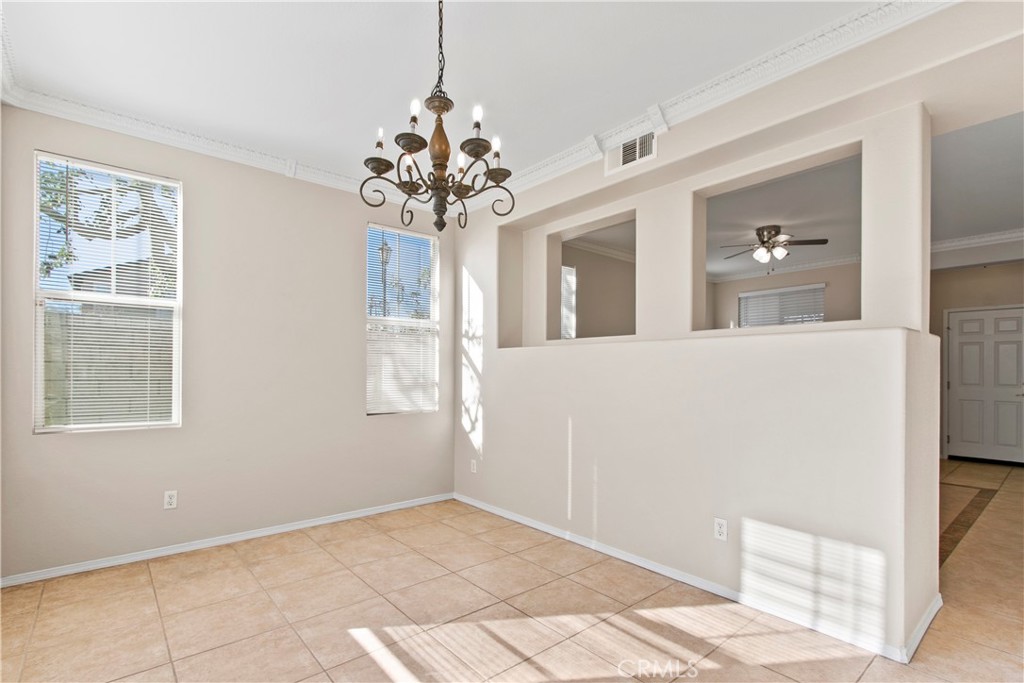6837 Cosmos Street Chino, CA 91710 - Photo 11 of 36 a view of a livingroom with a chandelier fan and windows