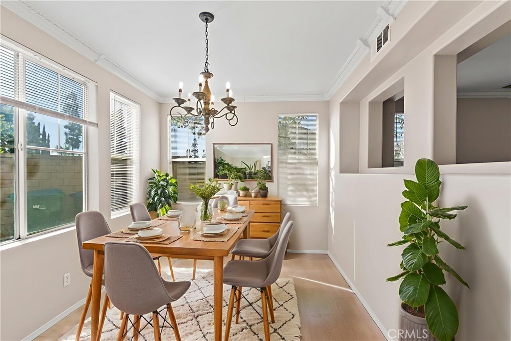 6837 Cosmos Street Chino, CA 91710 - Photo 13 of 36 a view of a dining room with furniture window and wooden floor