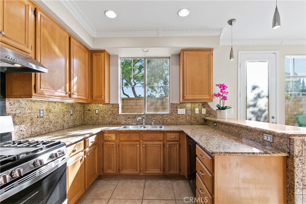 6837 Cosmos Street Chino, CA 91710 - Photo 16 of 36 a kitchen with a sink stove top oven and cabinets