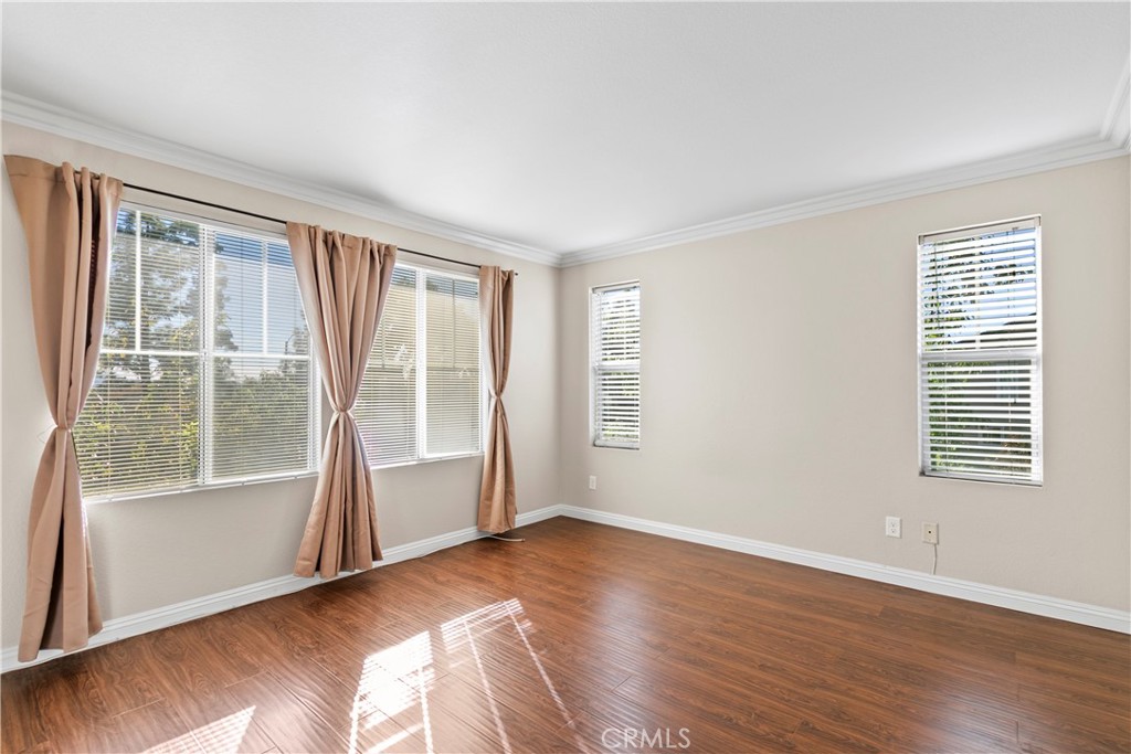 6837 Cosmos Street Chino, CA 91710 - Photo 17 of 36 a view of an empty room with wooden floor and a window
