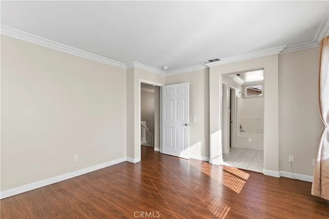 a bedroom with a large bed and a large window