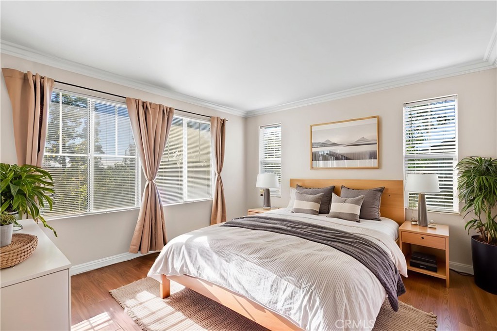 6837 Cosmos Street Chino, CA 91710 - Photo 19 of 36 a bedroom with a large bed and a large window