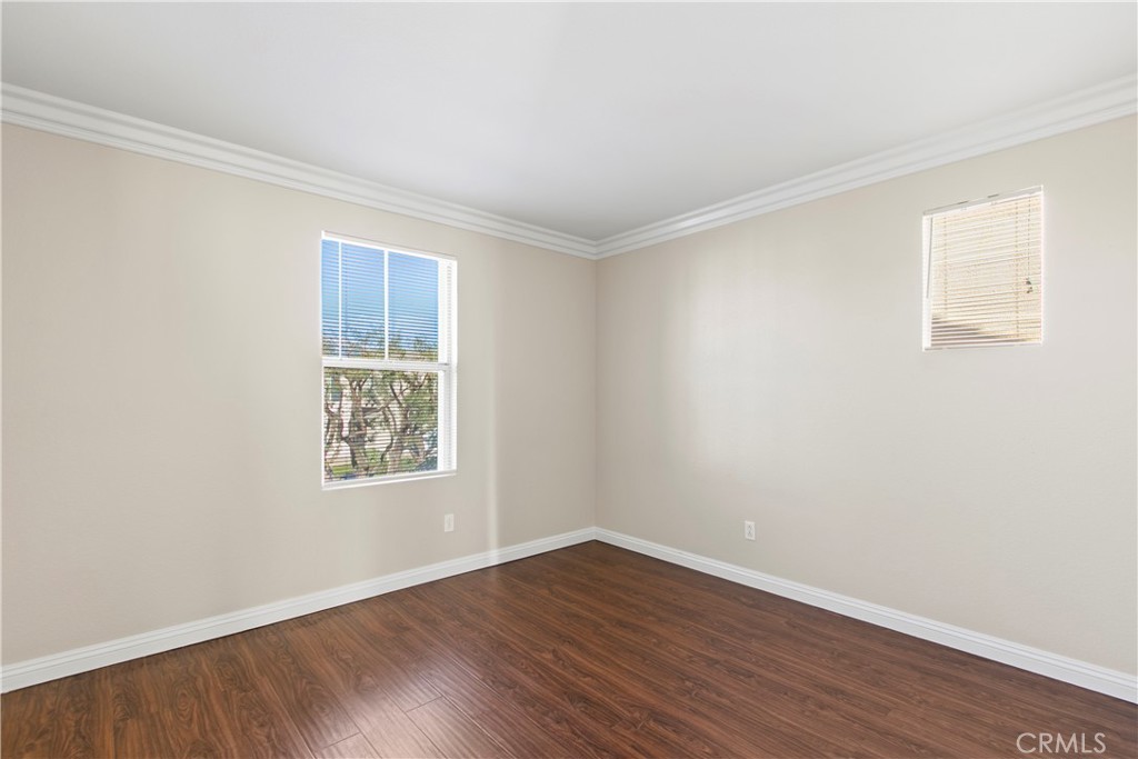 6837 Cosmos Street Chino, CA 91710 - Photo 24 of 36 an empty room with wooden floor and windows