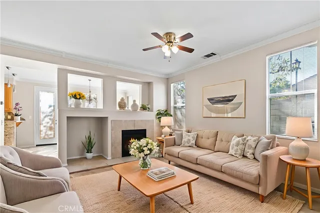 a living room with furniture a fireplace and a window