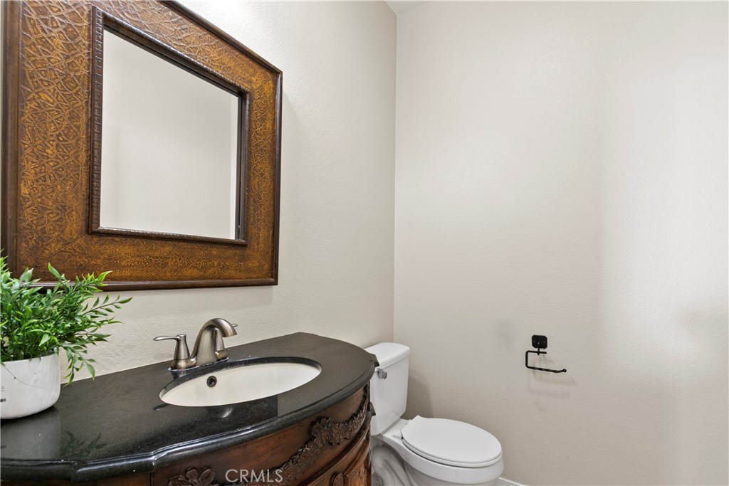 6837 Cosmos Street Chino, CA 91710 - Photo 7 of 36 a bathroom with a sink a toilet and mirror