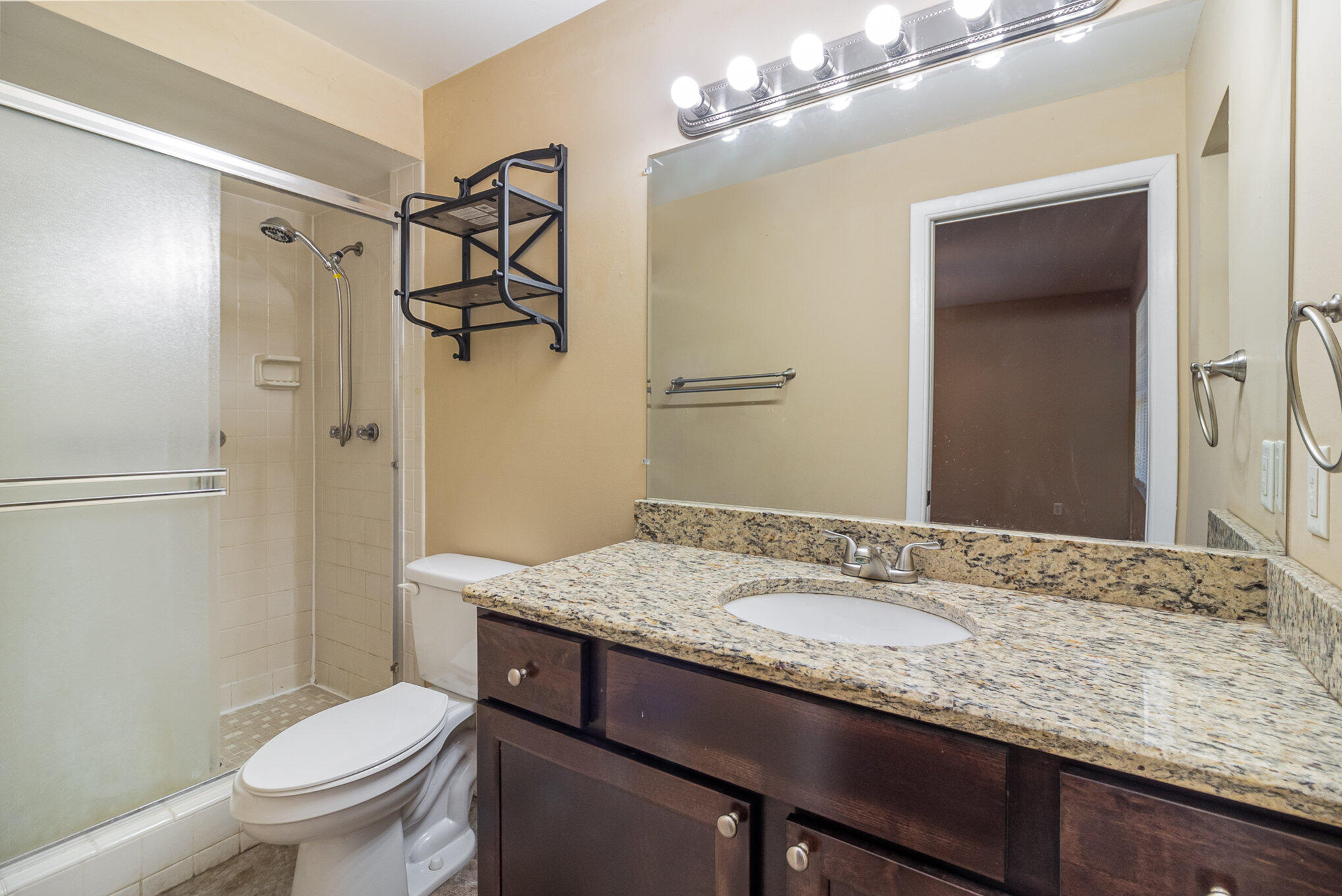 635 Croton Road Melbourne, FL 32935 - Photo 17 of 22 a bathroom with a granite countertop sink toilet and shower
