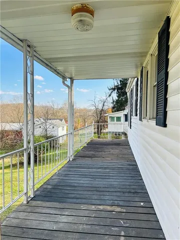 a view of balcony with wooden floor and outdoor seating
