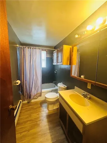 a bathroom with a sink mirror vanity and toilet