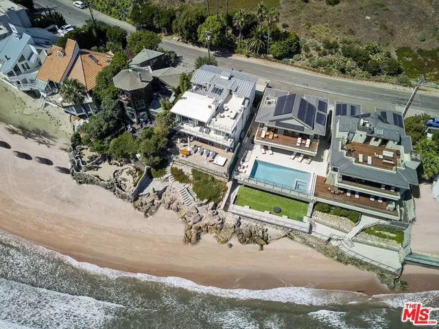 aerial view of a house with a yard and sitting area