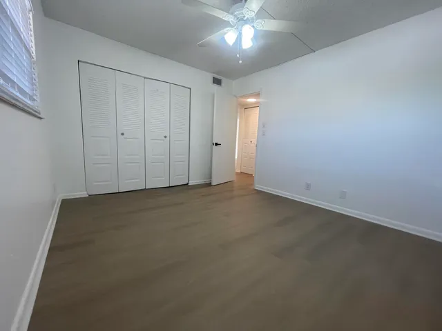 an empty room with a empty space and a ceiling fan