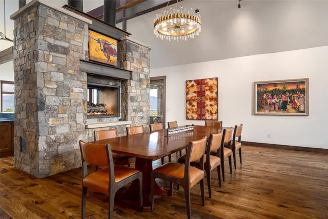 a dining table with chairs and a potted plant
