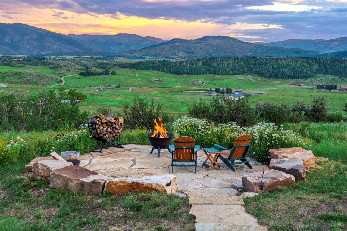 28100 Columbine Ridge Road Steamboat Springs, CO 80487 - Photo 17 of 43 a view of a table and chairs in backyard