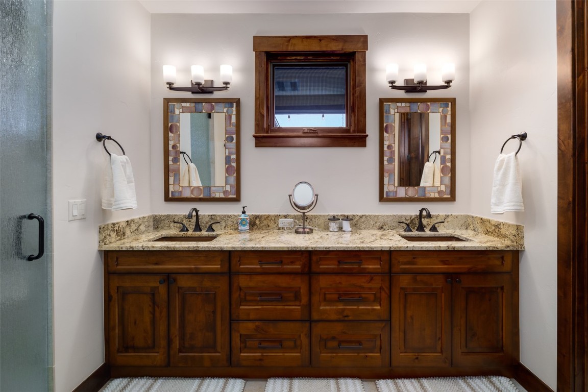 28100 Columbine Ridge Road Steamboat Springs, CO 80487 - Photo 24 of 43 a bathroom with double sink and a mirror
