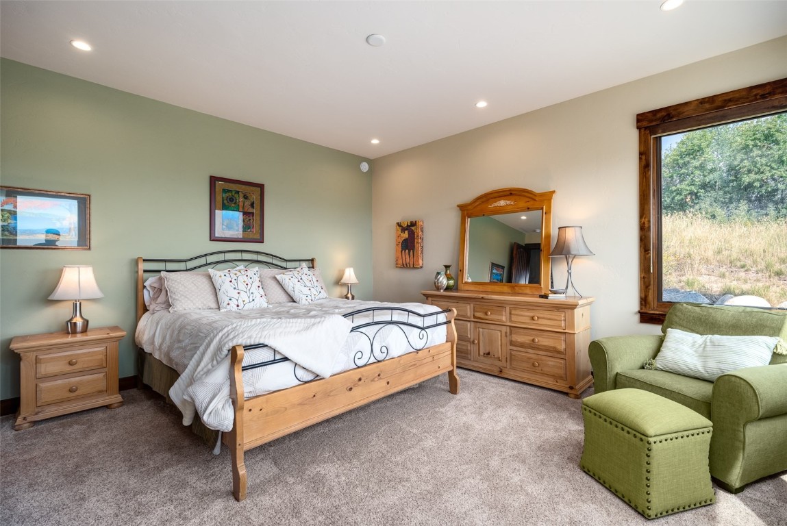 28100 Columbine Ridge Road Steamboat Springs, CO 80487 - Photo 28 of 43 a bedroom with a bed and a large window