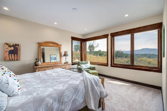 a bedroom with a large bed and a large window