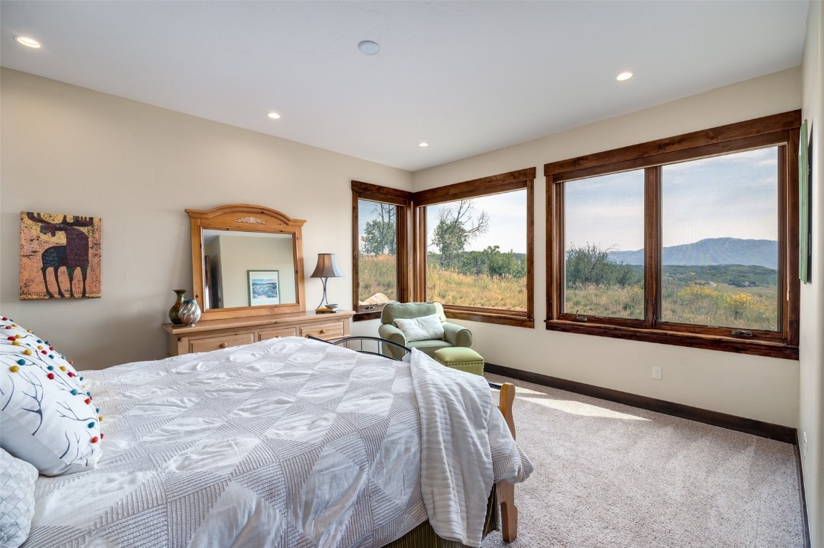 28100 Columbine Ridge Road Steamboat Springs, CO 80487 - Photo 29 of 43 a bedroom with a large bed and a large window