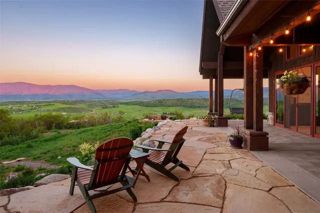 a living room with furniture large garden view and a flat screen tv