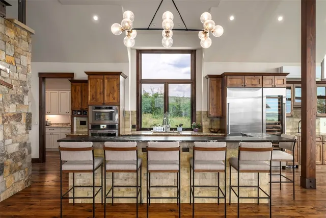 a room with chandelier and wooden floor