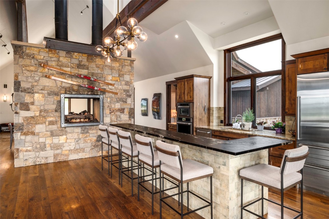 28100 Columbine Ridge Road Steamboat Springs, CO 80487 - Photo 10 of 43 a room with chandelier and wooden floor