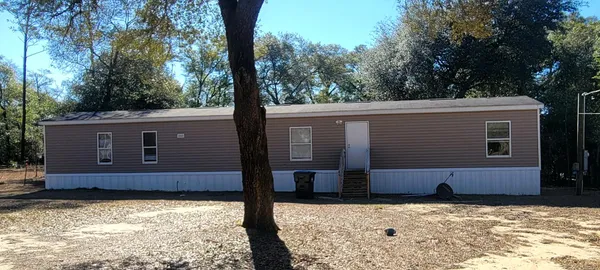 a backyard of a house with large trees