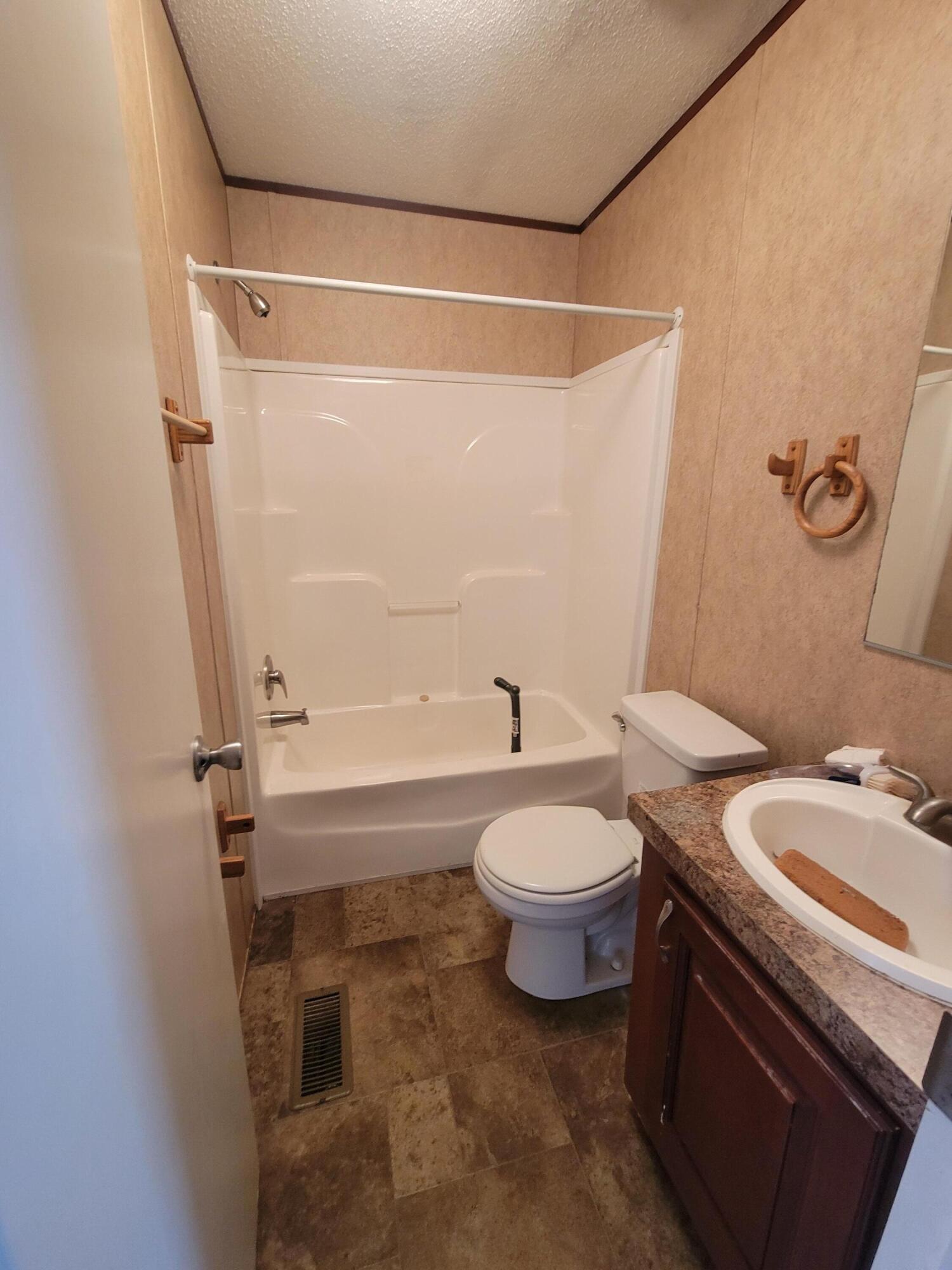 188 O'Daniels Way DeFuniak Springs, FL 32433 - Photo 14 of 17 a bathroom with a toilet a sink and a shower