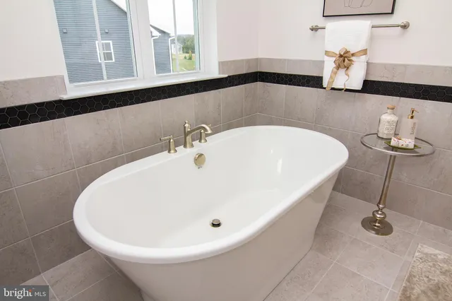 a bedroom with a potted plant and a chair