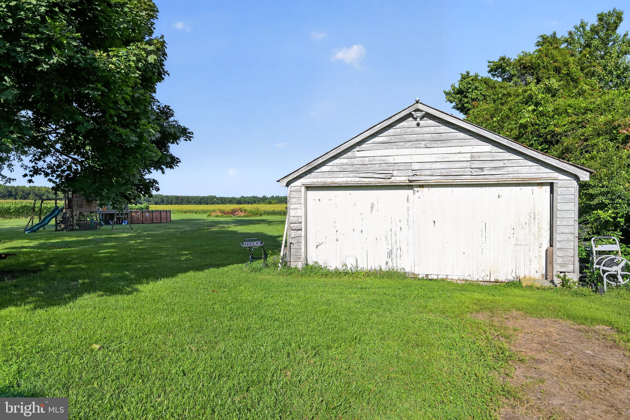 6132 Harmony Road Preston, MD 21655 - Photo 5 of 31 Charming shed amidst lush greenery.
