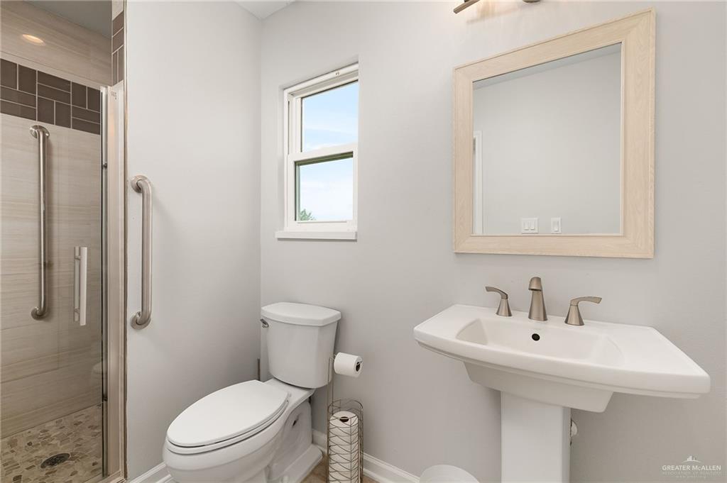 22172 North Olmito Road Rio Hondo, TX 78583 - Photo 21 of 33 a bathroom with a toilet sink shower and mirror