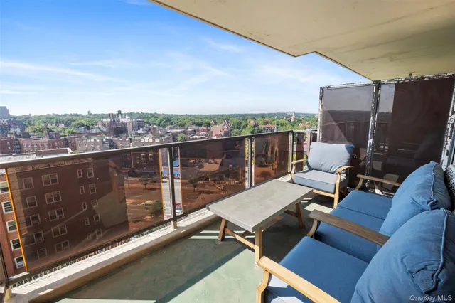 a terrace with outdoor seating and city view