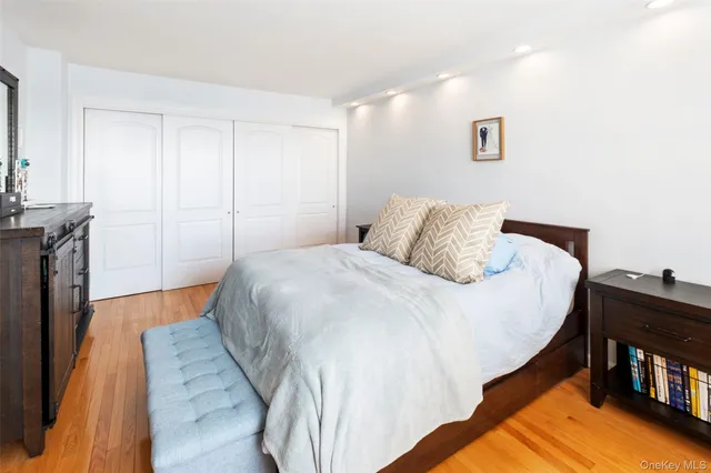 a bedroom with a bed and a book shelf