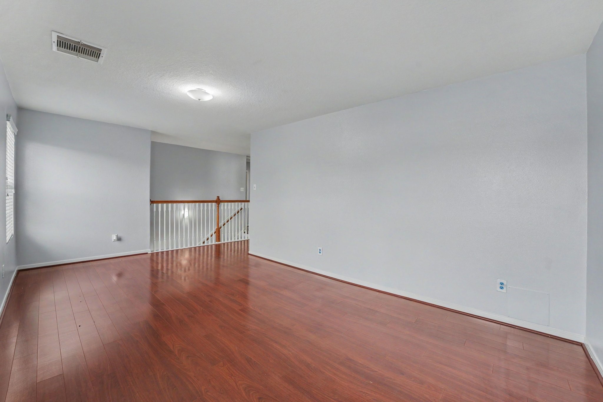 5622 Wasabi Lane Baytown, TX 77521 - Photo 18 of 29 a view of an empty room with wooden floor and a window