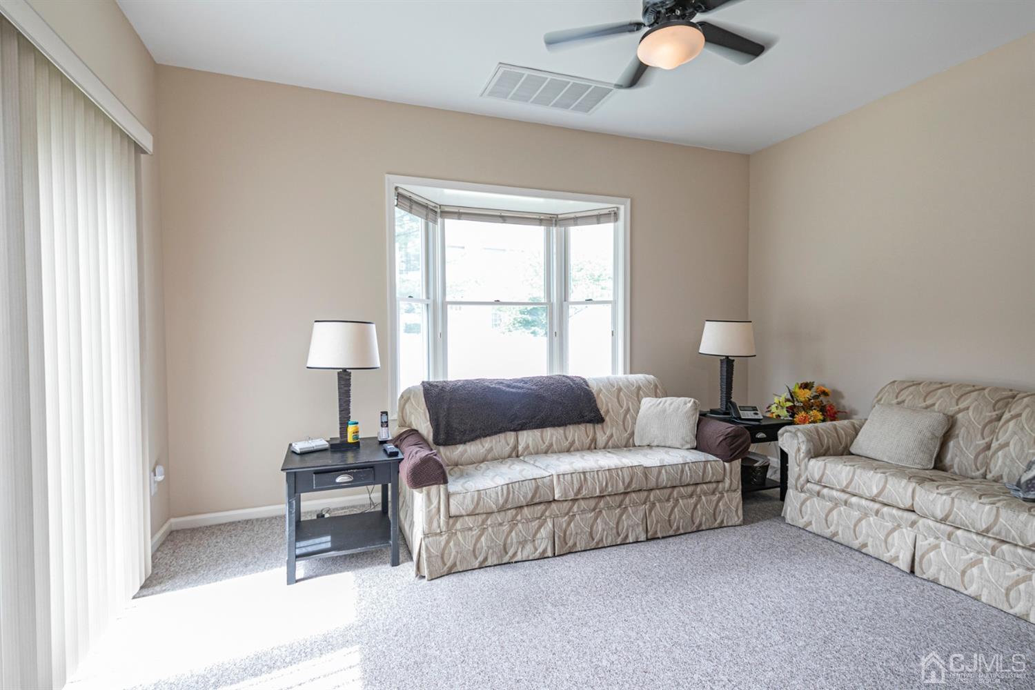 30 Aster Way Dayton, NJ 08810 - Photo 15 of 38 a living room with furniture and a lamp