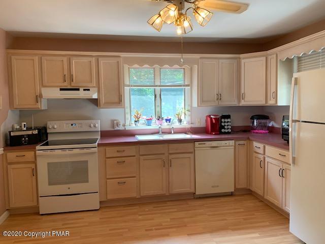 204 Winona Road Mount Pocono, PA 18344 - Photo 15 of 41 a kitchen with a stove a sink and white cabinets