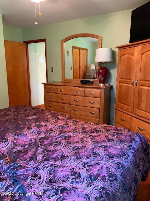 204 Winona Road Mount Pocono, PA 18344 - Photo 20 of 41 a bedroom with a bed and wooden floor