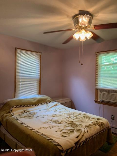 204 Winona Road Mount Pocono, PA 18344 - Photo 21 of 41 a bedroom with a bed and a chandelier