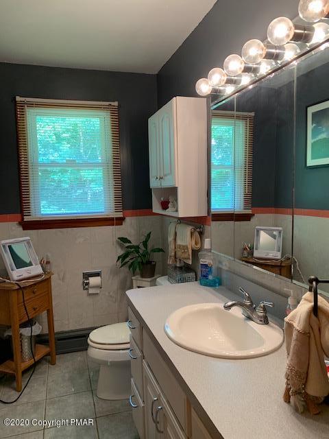 204 Winona Road Mount Pocono, PA 18344 - Photo 26 of 41 a bathroom with a toilet sink and mirror
